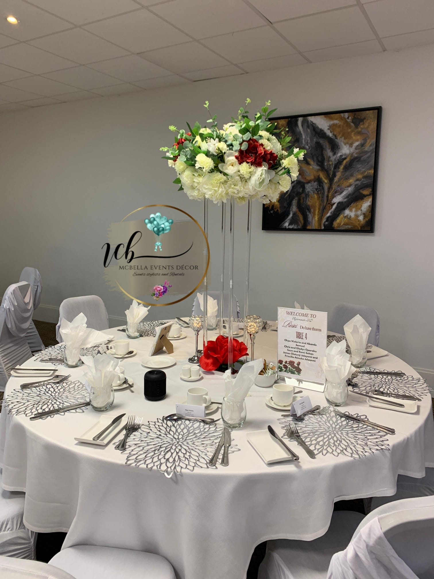 Elegant corporate event table setting with floral centerpieces and fine tableware by McBella Events Decor.